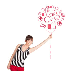 Happy young lady holding social icon balloon